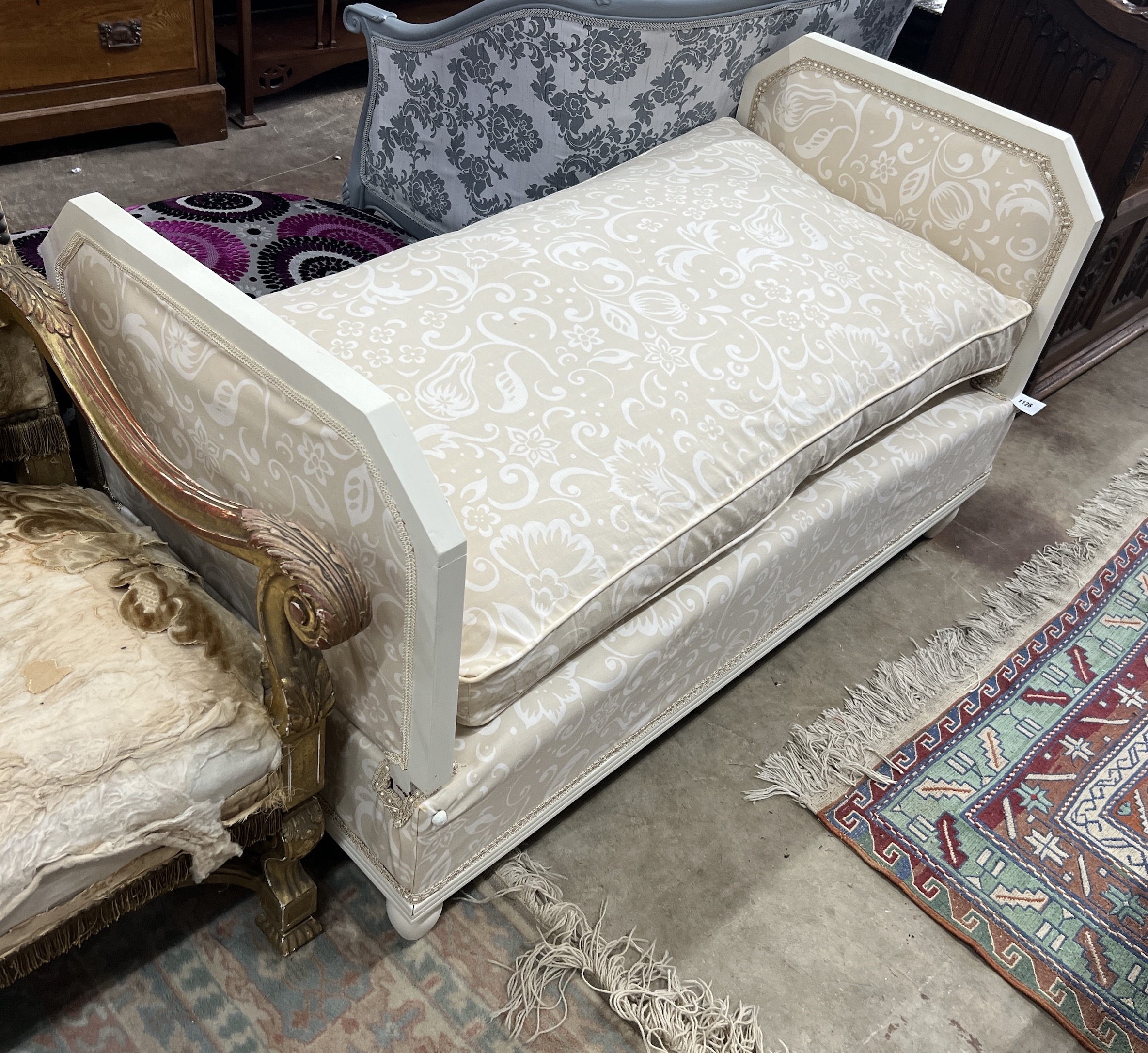 A French cream painted upholstered folding day bed, length 135cm, depth 68cm, height 77cm